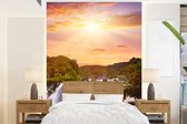 Behang - Fotobehang Waterval - Landschap - Zon - Wolken - Zonsondergang - Breedte 165 cm x hoogte 220 cm