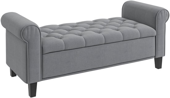 Grijze stoffen opbergbank met gecapitonneerd zitvlak en armleuningen.