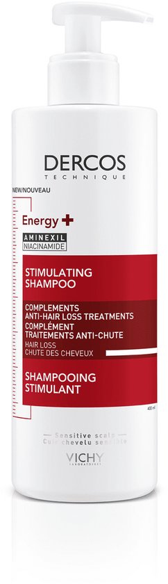 Een witte fles Vichy Dercos Energy+ Aminexil Niacinamide Stimulerende Shampoo met een rood en wit label.