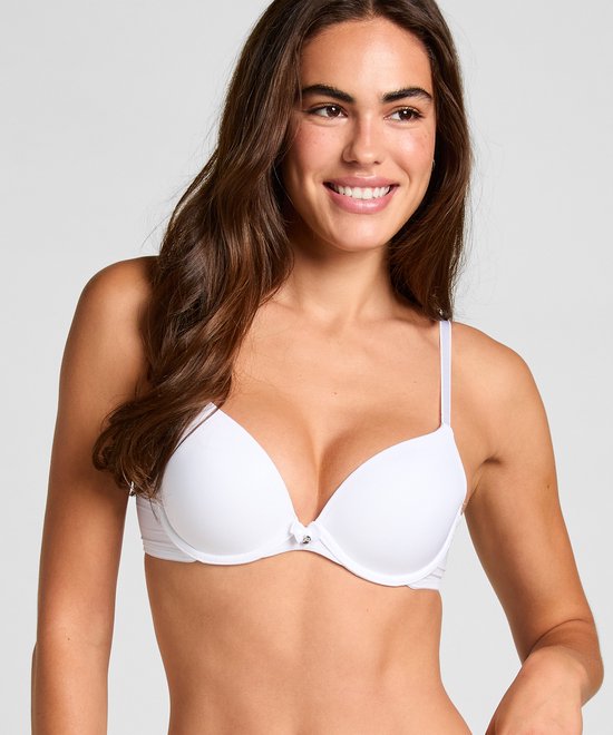 Model met witte voorgevormde plunge bh, met verstelbare bandjes en een klein strikje aan de voorkant.