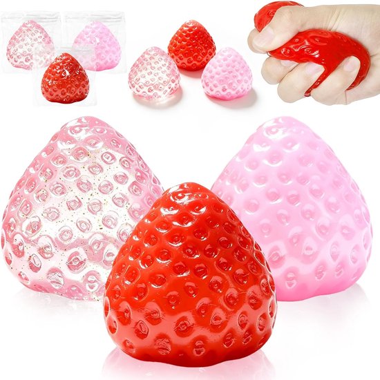 Rode en roze squishy aardbeien, één roze met glitters. Worden in de hand geknepen.