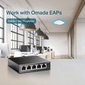 Een zwarte TP-Link 5-Poorts Gigabit Desktop Switch met 4-Poort PoE, geplaatst op een bureau in een modern kantoor, met tekst"Work with Omada EAPs".