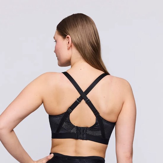 Achterkant van een zwarte sportbeha met geometrisch patroon, gekruiste bandjes en sluiting.
