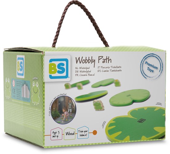 Doos met 'Wobbly Path' speelgoed. Groene leliebladvormige speelplaten met kikkerfiguurtjes. Tekst: 'Premium Toys', 'Train your balance!'.
