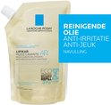 Gele navulzak met witte dop en blauw logo. Tekst "REINIGENDE OLIE ANTI-IRRITATIE ANTI-JEUK NAVULLING". 400 ml.