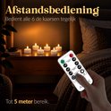 Een hand met een afstandsbediening bedient zes brandende theelichtjes op een nachtkastje.