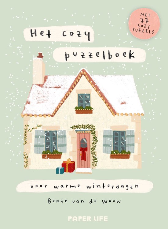 Cover met een geïllustreerd huis in de sneeuw, titel Het cozy puzzelboek en 77 puzzels voor warme winterdagen.