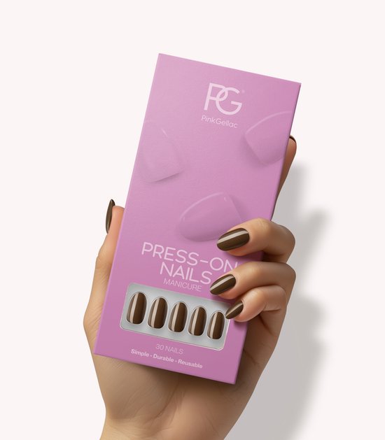 Roze verpakking met Pink Gellac "PRESS-ON NAILS" en een voorbeeld van ronde, medium, donkerbruine neptallen. Een hand met gelakte donkerbruine nagels houdt de verpakking vast.