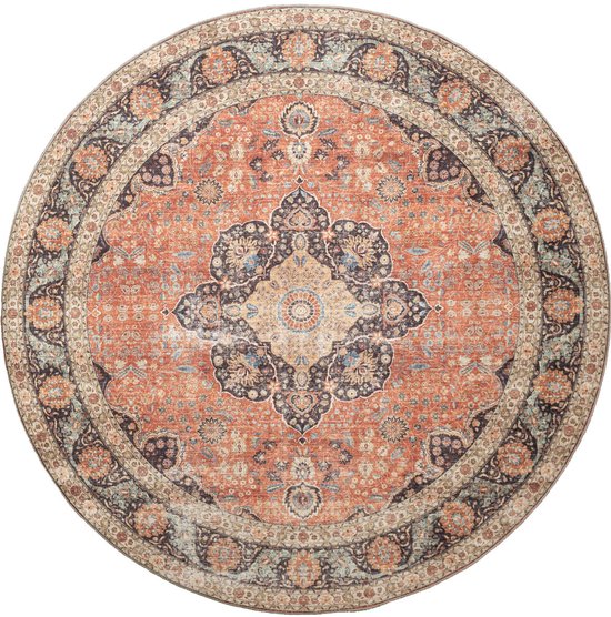 Tapis rond avec un motif médaillon oriental en terre cuite, bleu foncé et crème, sur fond blanc.