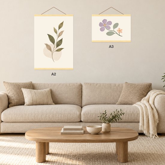 Woonkamerinterieur met een A2 posterhanger en een A3 posterhanger aan de muur boven een bank.