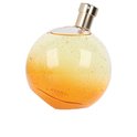 Elixir des Merveilles Eau de Parfum. Rond parfumflesje met goudkleurige dop, oranje-geel glas met fijne gouden spikkels.