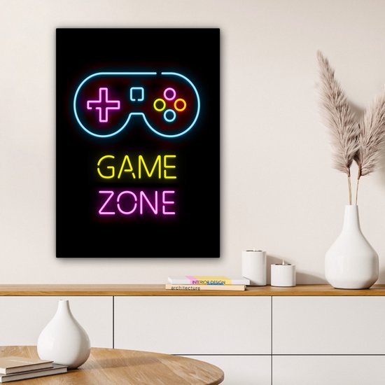 Toile avec une manette style néon et le texte 'GAME ZONE' en bleu, jaune et rose, au-dessus d'une commode.
