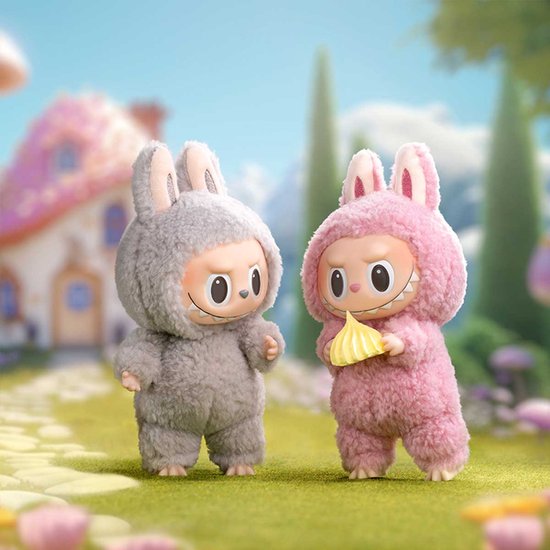 Twee pluizige figuurtjes in konijnenkostuum, één grijs en één roze, in een grasrijke omgeving.