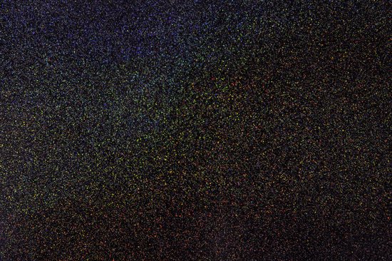 Une surface noire avec un arc-en-ciel de fines particules de paillettes scintillantes.