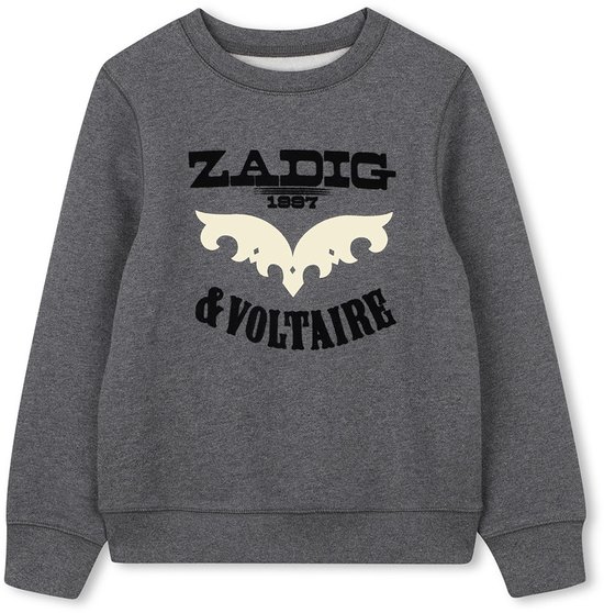 Sweat-shirt gris foncé avec le texte "ZADIG 1997 & VOLTAIRE" et une décoration d'ailes stylisée.