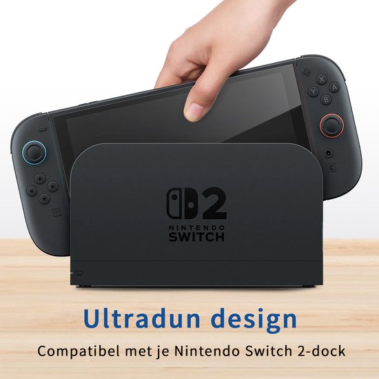 Hand plaatst Nintendo Switch in een zwarte dock. "Ultradun design Compatibel met je Nintendo Switch 2-dock".