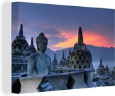 Canvas Schilderij Oranje lucht boven de Borobudur tempel in Indonesië - 90x60 cm - Wanddecoratie