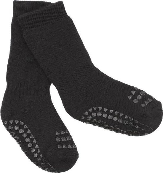 Chaussettes noires avec des points et triangles antidérapants gris sur le talon et la semelle.