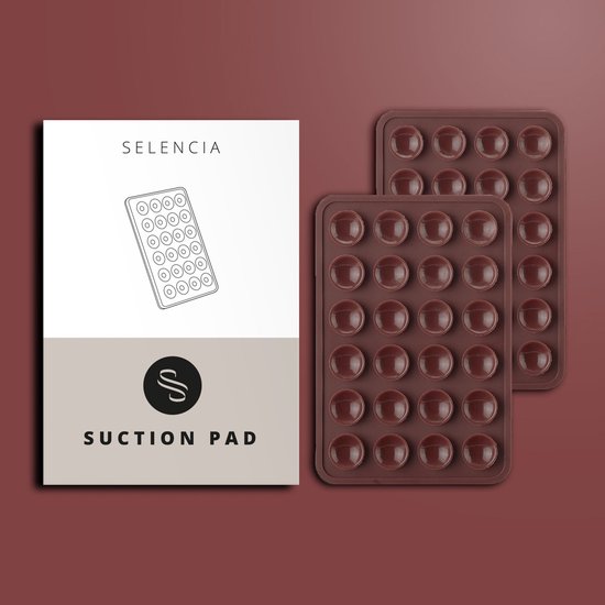 Selencia Suction Pad verpakking naast twee bruine zuignap pads met 24 rondjes.