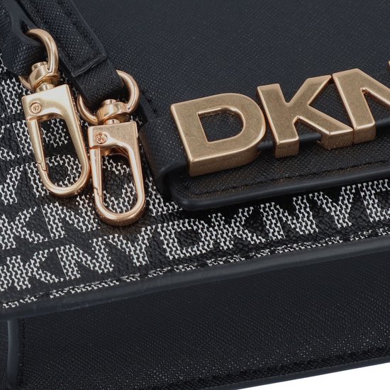 Close-up van de goudkleurige 'DKNY' letters en karabijnsluitingen op de zwarte tas.