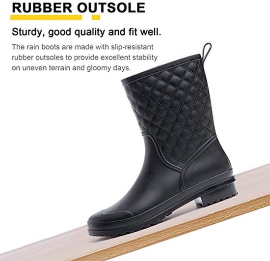 Zwarte regenlaars met antislipzool op een hellend houten oppervlak voor extra grip en stabiliteit.