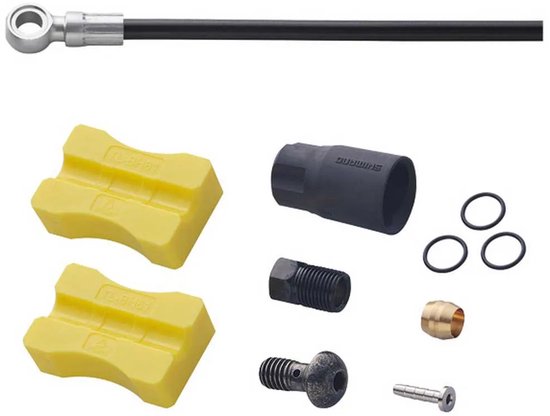 Shimano remleiding met gele blokjes, zwarte slang, moertjes en ringetjes.