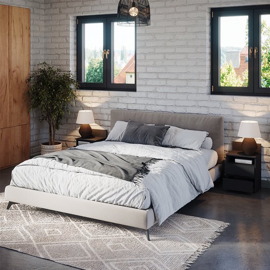 Une chambre avec un lit double, deux tables de nuit noires avec lampes, et une armoire en bois.