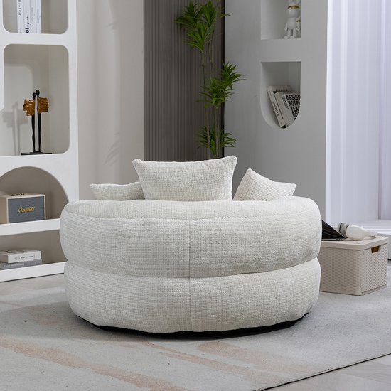 Grote, ronde, beige fauteuil met grove textuur, in een modern ingerichte kamer.