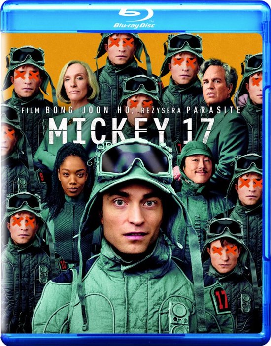 Filmhoes met Robert Pattinson vooraan, omringd door andere personen met oranje markeringen op hun gezicht. De tekst "MICKEY 17" staat centraal.