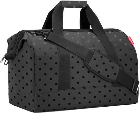 Zwarte weekendtas met handvatten, schouderband en een subtiel stippenpatroon.