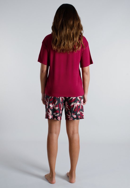 Vrouw, achterkant, draagt bordeauxrode pyjamaset met korte mouwen en een broek met bladerenprint.