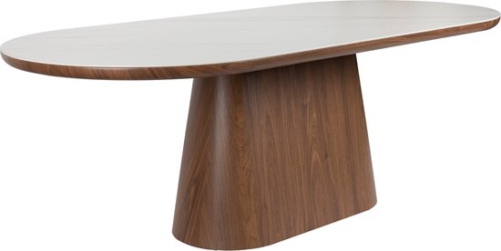 Table ovale avec plateau aspect marbre blanc et un large piétement ovale en bois couleur noyer.