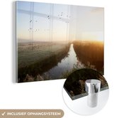 MuchoWow® Glasschilderij 150x100 cm - Schilderij acrylglas - Vliegende ganzen tijdens zonsopgang - Foto op glas - Schilderijen