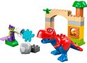 Rode en blauwe T-Rex met groene goblin op paars platform met water.