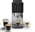Grijze Krups volautomatische espressomachine met drie glazen mokken koffie.