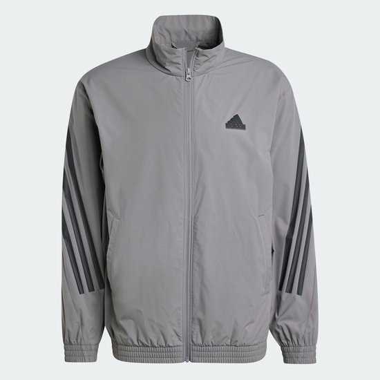 Grijs Adidas trainingsjack met zwarte 3-strepen op de mouwen en een Adidas logo op de borst.