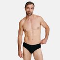 Homme en sous-vêtements noirs, mannequin avec barbe grise et bras tatoués.