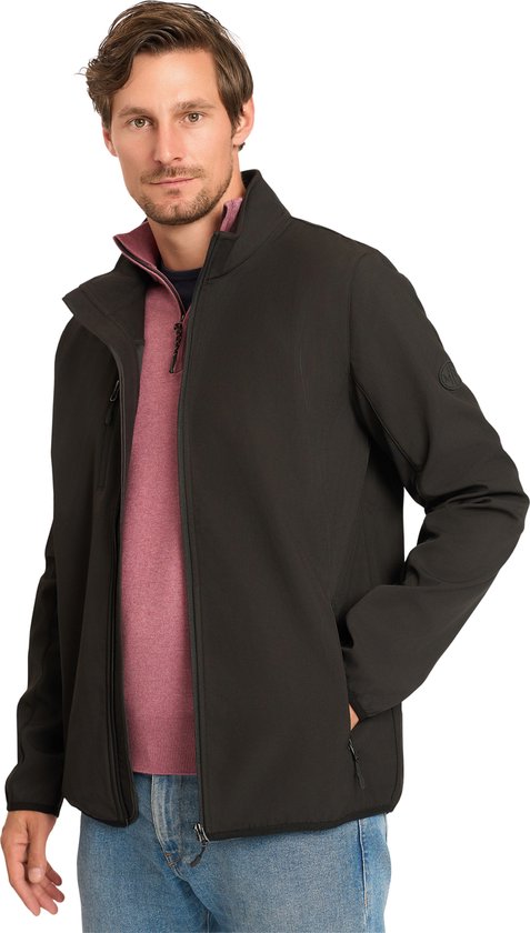Man in zwart softshell jack met rits, roze trui en spijkerbroek.