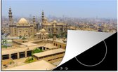 KitchenYeah® Inductie beschermer 76x51.5 cm - Felle zon schijnt over de gebouwen in de Egyptische stad Caïro - Kookplaataccessoires - Afdekplaat voor kookplaat - Inductiebeschermer - Inductiemat - Inductieplaat mat