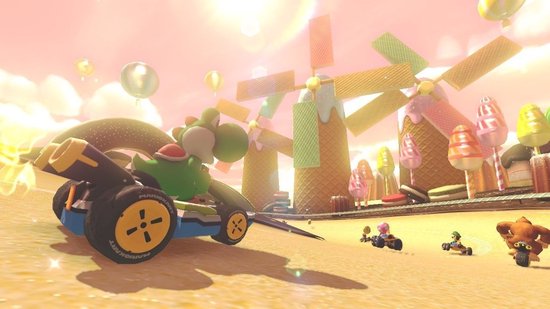 Yoshi racet op een kartbaan met kleurrijke gebouwen die op snoepjes lijken. Molens op de achtergrond.