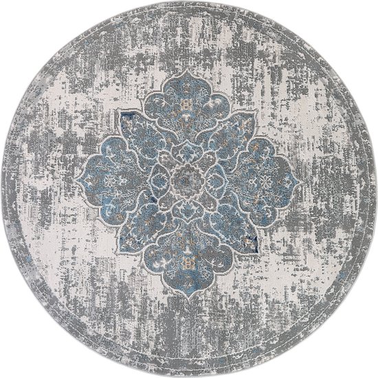 Tapis rond gris avec un motif floral bleu et gris détaillé, d'aspect vintage, au centre et une texture usée.