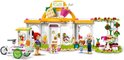 LEGO Friends biologisch café met smoothiekar, twee meisjes en een oudere man. 'Café' staat op het bord.