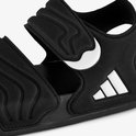 Close-up van zwarte Adidas Adilette sandalen voor kinderen met witte streeplogo's.