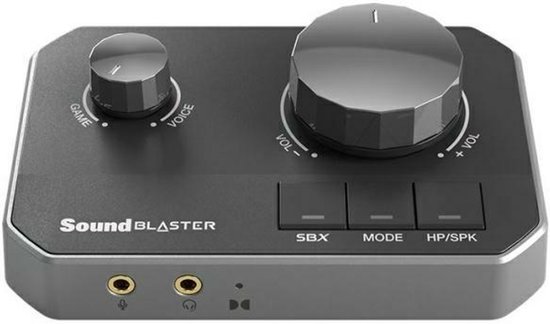 Zwarte Sound Blaster met twee draaiknoppen en drie knoppen: SBX, MODE en HP/SPK. Twee audio-ingangen aan de voorzijde.