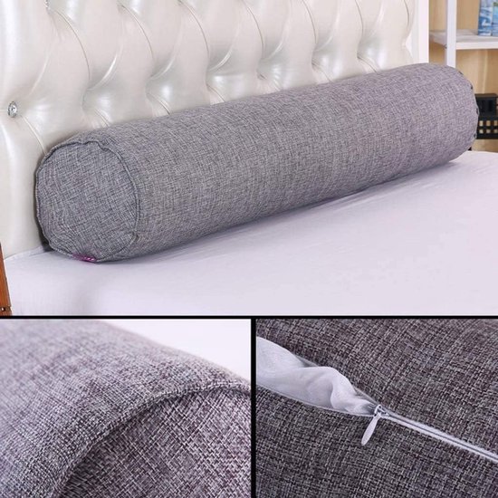 Grijs rolkussen op een bed met witte lakens. Detail van de textuur en de ritssluiting.