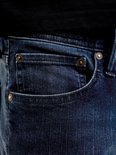 Detailopname van de jeanszak met klinknagels.