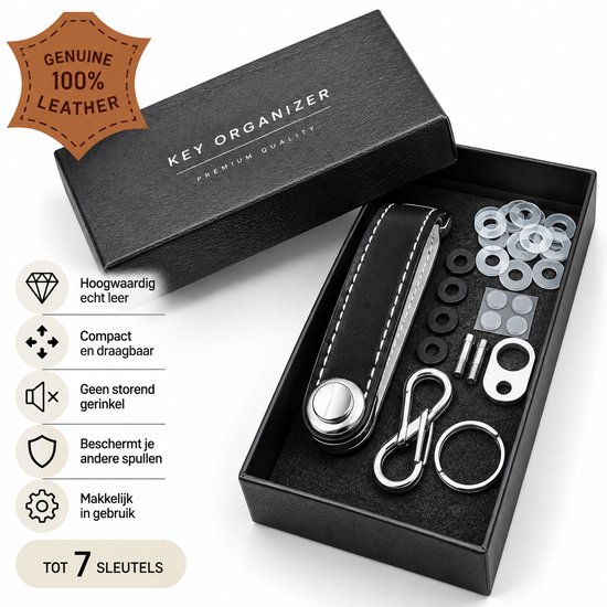 Zwarte, leren sleutelorganizer in een open doos. Bevat 7 sleutels, bevestigingsmateriaal en extra ringen. Gemaakt van 100% echt leer.