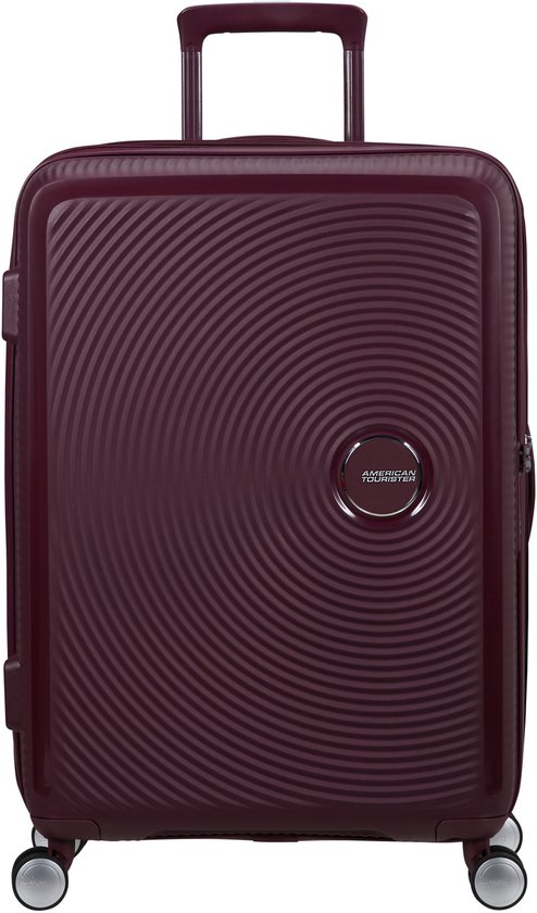 Bordeauxrode American Tourister spinner koffer met cirkelvormig patroon en uitschuifbare handgreep.