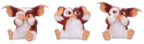 Trois figurines Gizmo couvrant leurs yeux, oreilles et bouche, assises.