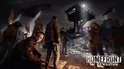 Groep mensen met spandoeken voor een toren in Homefront The Revolution.